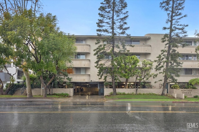 view of property featuring uncovered parking