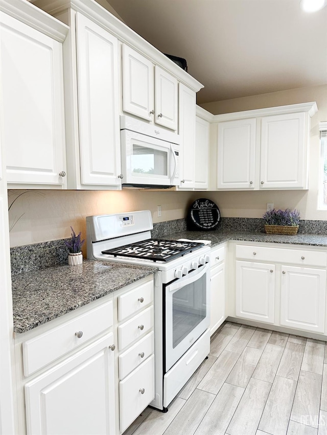 9400 Carriage Creek Ct, Bakersfield, CA 93311 - kitchen featuring white appliances, white cabinets, stone counters, and light wood-style flooring