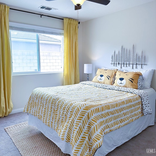 carpeted bedroom featuring baseboards, ceiling fan, and visible vents
