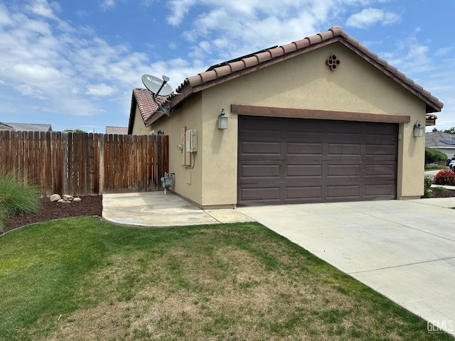 9400 Carriage Creek Ct, Bakersfield, CA 93311 - view of side of home with stucco siding, an attached garage, driveway, and a tiled roof