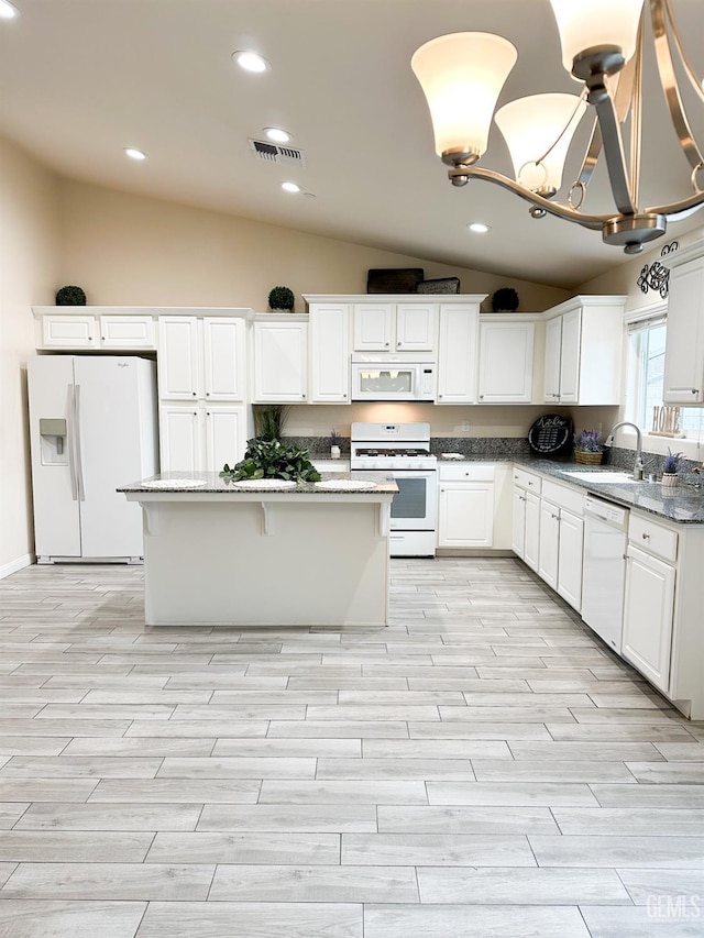 9400 Carriage Creek Ct, Bakersfield, CA 93311 - kitchen featuring white appliances, a sink, vaulted ceiling, light wood finished floors, and white cabinets