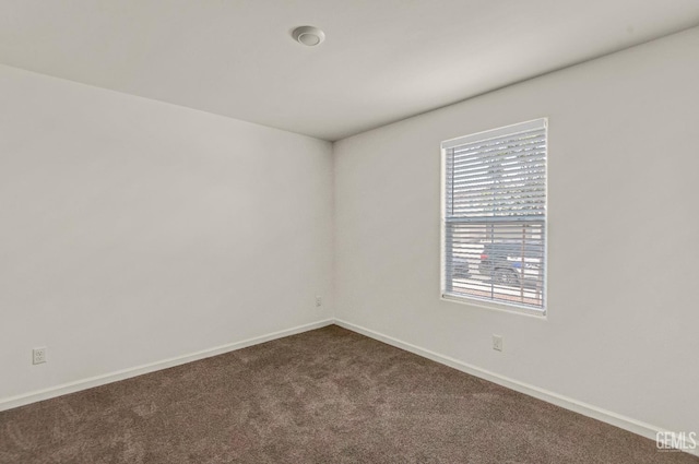 6003 Vespucci Ave, Bakersfield, CA 93313 - spare room with healthy amount of natural light and dark carpet