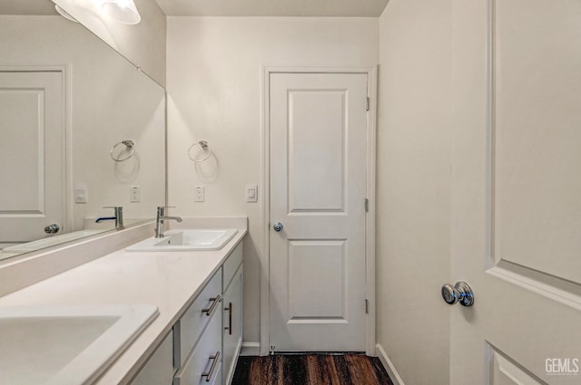 6003 Vespucci Ave, Bakersfield, CA 93313 - bathroom featuring double vanity and wood finished floors