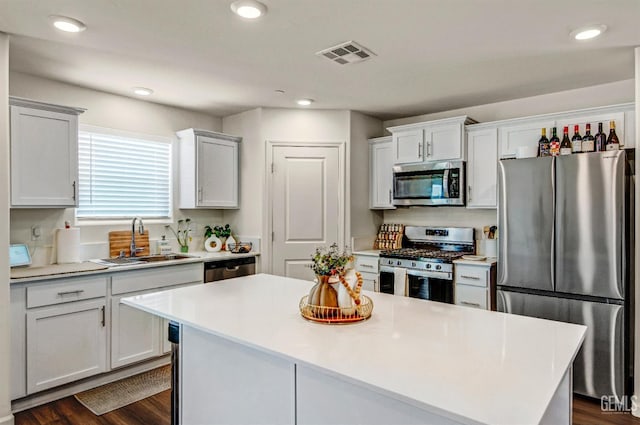 6003 Vespucci Ave, Bakersfield, CA 93313 - kitchen with stainless steel appliances, light countertops, a kitchen island, dark wood finished floors, and recessed lighting