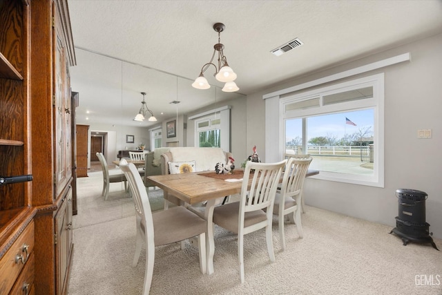 dining space with light colored carpet and visible vents