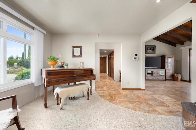 living area with lofted ceiling with beams and baseboards