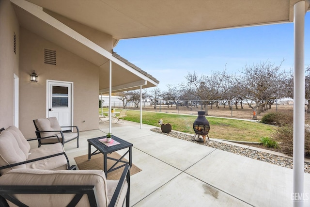 view of patio featuring an outdoor hangout area, fence, and visible vents