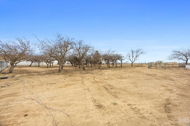 view of yard featuring fence and a rural view