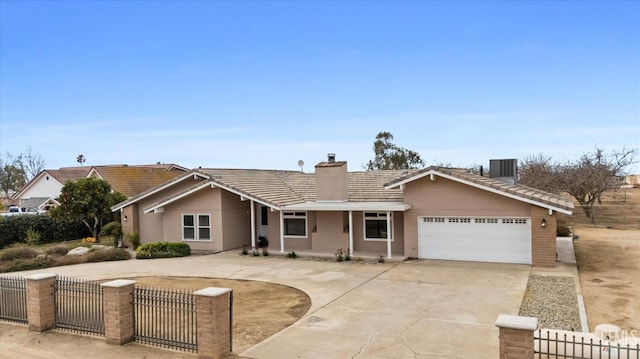 ranch-style house featuring driveway, a garage, a fenced front yard, a chimney, and stucco siding