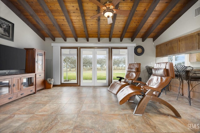 unfurnished room featuring plenty of natural light and beamed ceiling