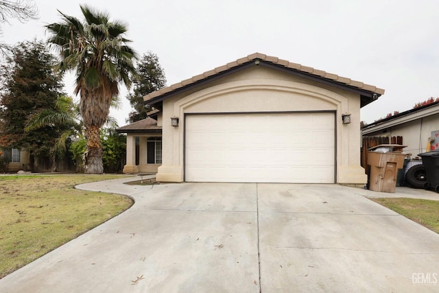 view of front facade with a garage, driveway, a front lawn, and stucco siding