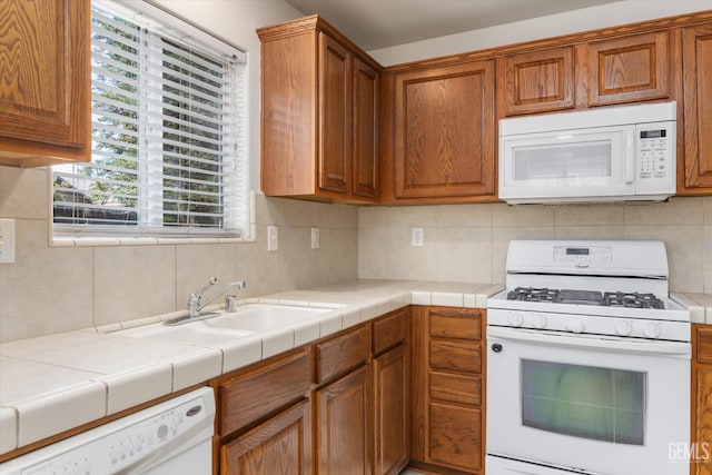 11018 Sonoma Creek Ct, Bakersfield, CA 93312 - kitchen featuring white appliances, tasteful backsplash, brown cabinetry, and light countertops