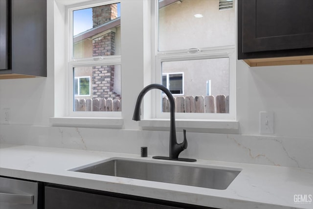 329 F St, Bakersfield, CA 93304 - kitchen with a sink, plenty of natural light, light stone countertops, and dishwasher