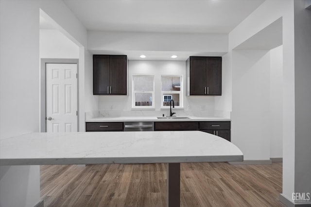 329 F St, Bakersfield, CA 93304 - kitchen with a sink, dark brown cabinetry, wood finished floors, baseboards, and recessed lighting