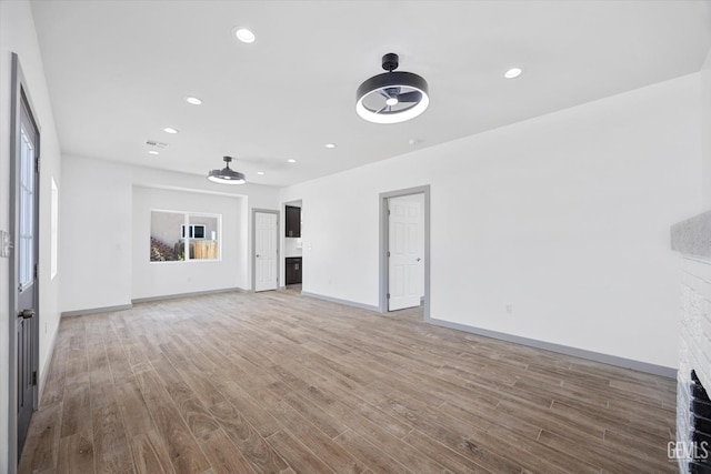 329 F St, Bakersfield, CA 93304 - unfurnished living room featuring a fireplace, wood finished floors, baseboards, and recessed lighting
