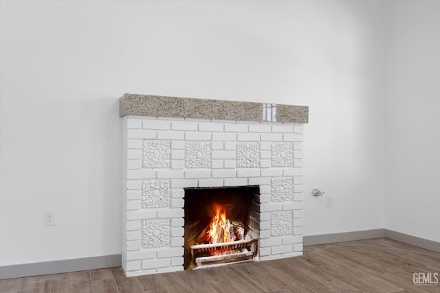 329 F St, Bakersfield, CA 93304 - detailed view of a fireplace, baseboards, and wood finished floors