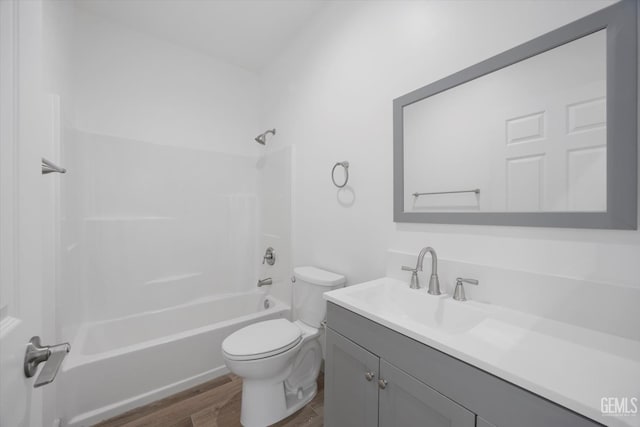 329 F St, Bakersfield, CA 93304 - bathroom with wood finished floors, toilet, vanity, and bathing tub / shower combination