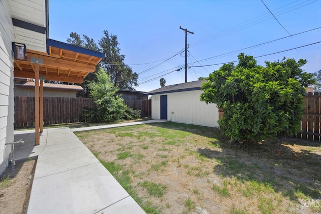 329 F St, Bakersfield, CA 93304 - fenced backyard featuring an outdoor structure and a patio