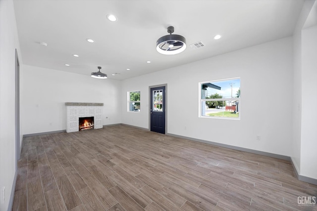 329 F St, Bakersfield, CA 93304 - unfurnished living room featuring wood finished floors, recessed lighting, a fireplace, and baseboards