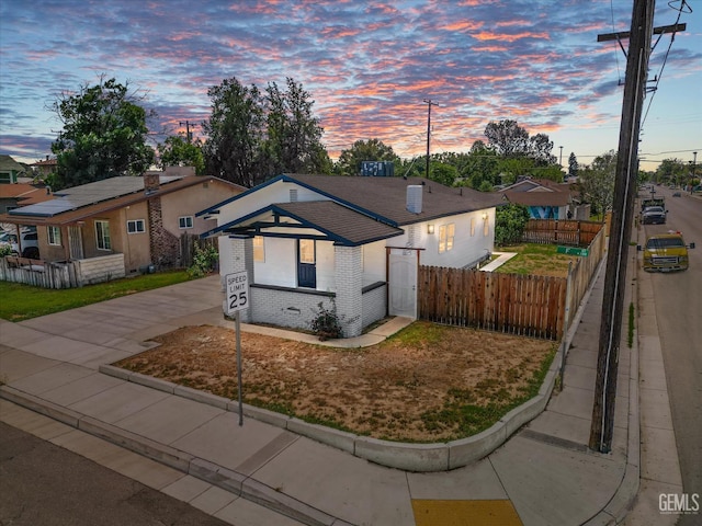 329 F St, Bakersfield, CA 93304 - bungalow-style home featuring brick siding, concrete driveway, and fence