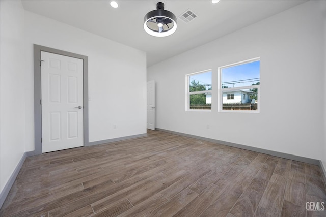 329 F St, Bakersfield, CA 93304 - unfurnished room with wood finished floors, baseboards, and recessed lighting