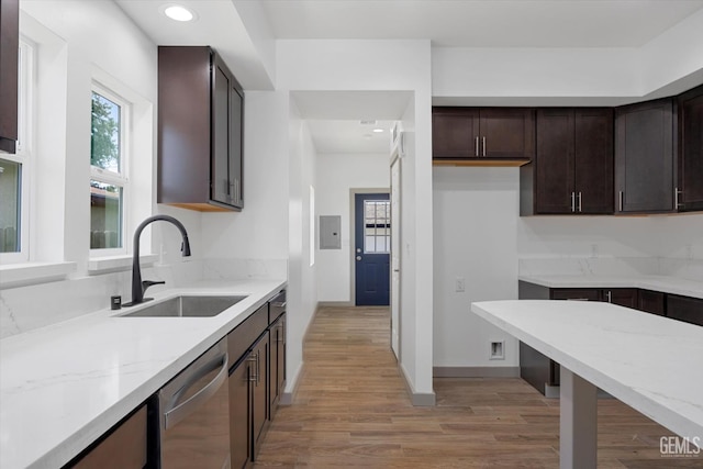 329 F St, Bakersfield, CA 93304 - kitchen featuring a sink, dishwasher, light stone countertops, light wood finished floors, and dark brown cabinets