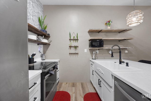 9200 Bridget Leigh Way, Bakersfield, CA 93312 - kitchen with open shelves, appliances with stainless steel finishes, light wood-style floors, and light countertops