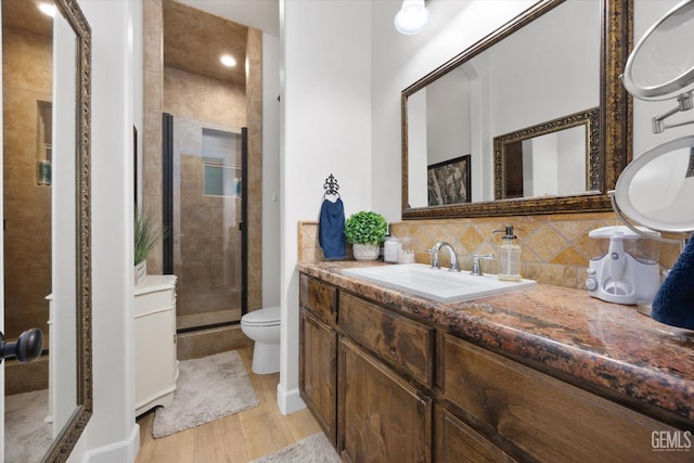 9200 Bridget Leigh Way, Bakersfield, CA 93312 - bathroom featuring a shower stall, wood finished floors, vanity, and backsplash