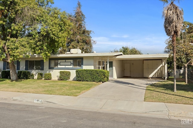 ranch-style home with a front lawn and a carport