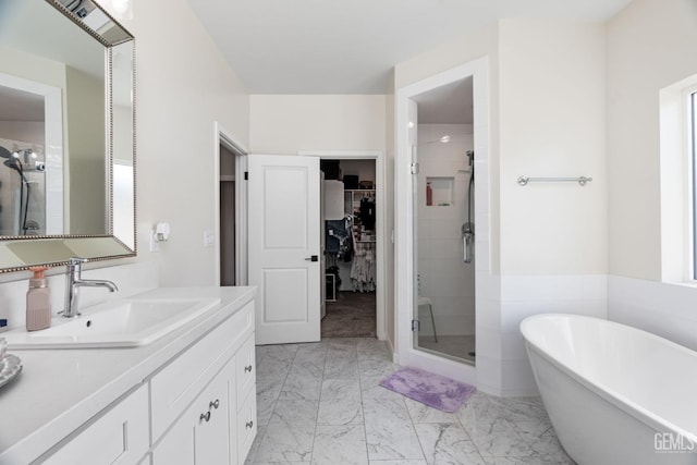 bathroom with vanity and separate shower and tub