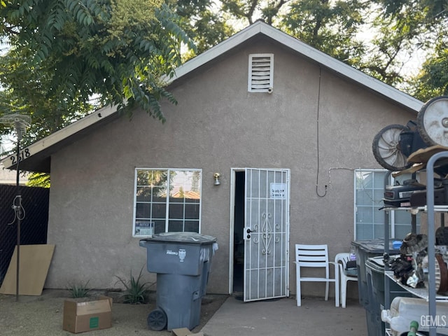 back of property featuring stucco siding