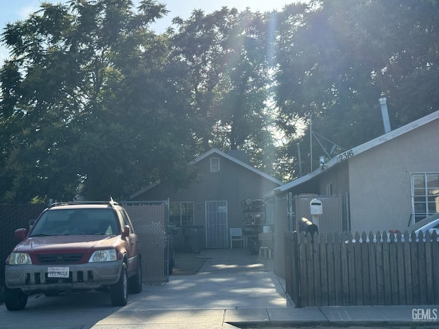 view of home's exterior featuring stucco siding and fence