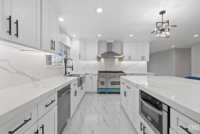 kitchen with wall chimney range hood, appliances with stainless steel finishes, recessed lighting, tasteful backsplash, and white cabinets