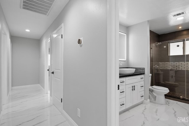 bathroom with marble look tiles, toilet, a stall shower, baseboards, and recessed lighting