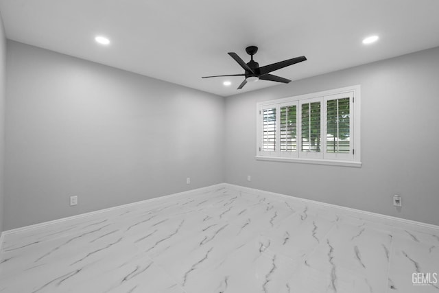 spare room featuring recessed lighting, baseboards, ceiling fan, and marble finish floors