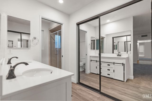 full bathroom featuring recessed lighting, a shower stall, toilet, and vanity