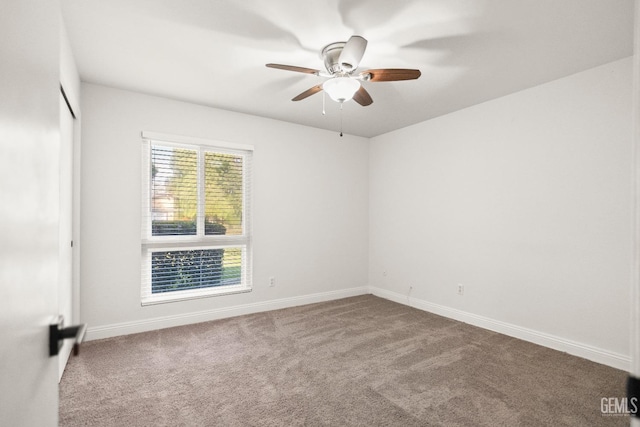 empty room with baseboards, carpet, and ceiling fan
