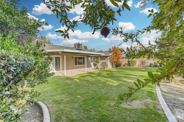 view of yard with fence, a patio area, and cooling unit