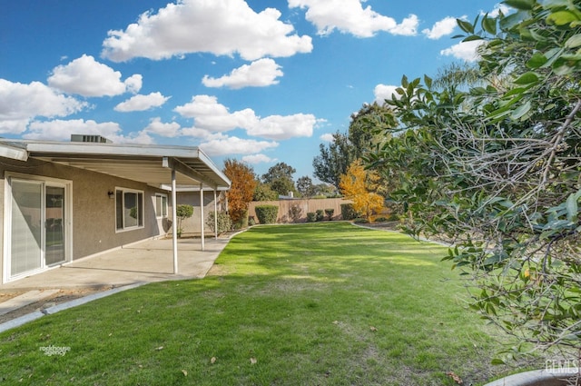 view of yard featuring fence and a patio