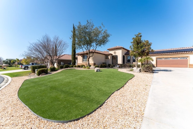 mediterranean / spanish-style house featuring a garage, a tiled roof, a front lawn, and stucco siding