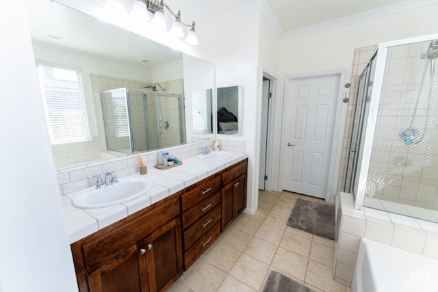 full bath featuring double vanity, a stall shower, ornamental molding, and a sink