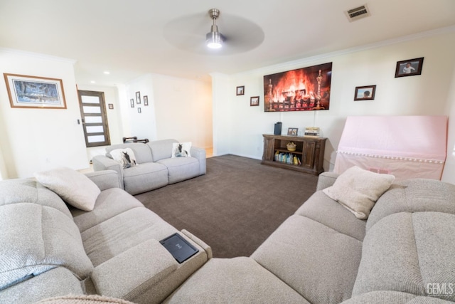 living area with carpet floors, visible vents, and ornamental molding