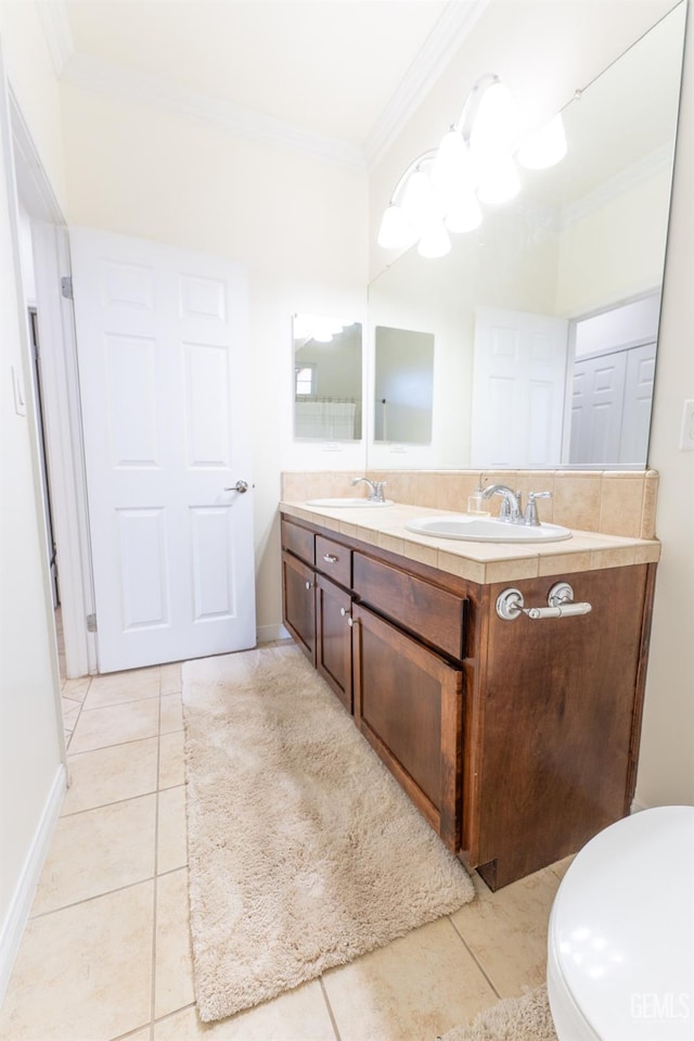 bathroom featuring double vanity, ornamental molding, and a sink