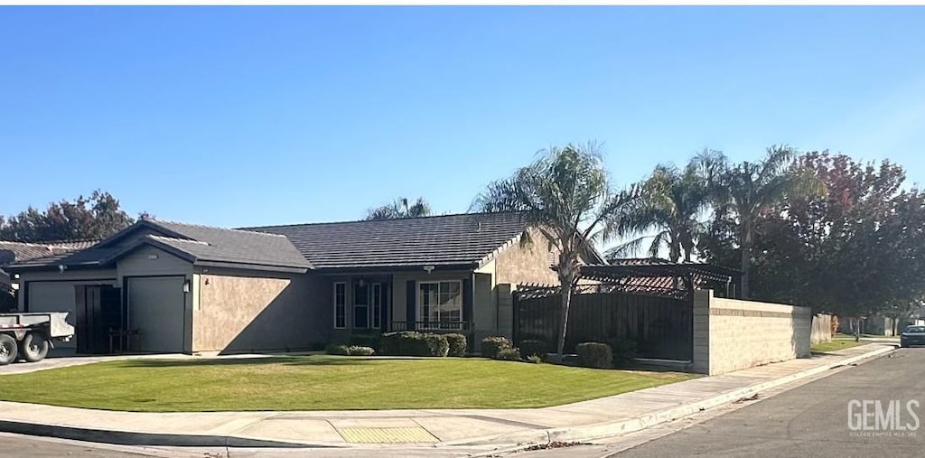 view of front of property with a garage and a front yard