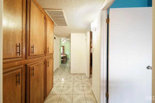 5116 Sherman Ave, Bakersfield, CA 93309 - hall featuring light tile patterned floors and a textured ceiling