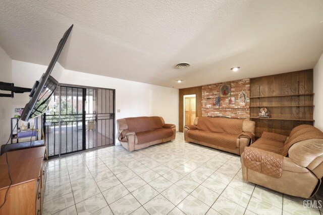 5116 Sherman Ave, Bakersfield, CA 93309 - living room featuring wooden walls and a textured ceiling