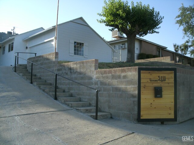 3111 Bucknell St, Bakersfield, CA 93305 - view of front of home with stairway and an attached garage