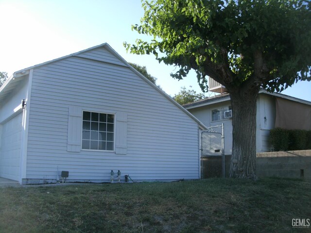 3111 Bucknell St, Bakersfield, CA 93305 - back of property featuring a garage and a lawn