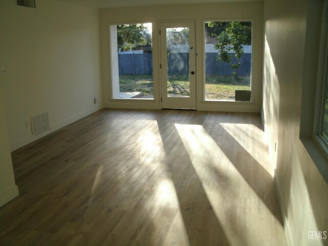 3111 Bucknell St, Bakersfield, CA 93305 - unfurnished room featuring plenty of natural light, wood finished floors, and baseboards