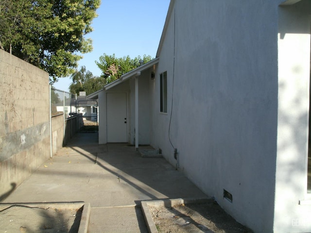 3111 Bucknell St, Bakersfield, CA 93305 - view of side of property featuring stucco siding, a patio, and crawl space